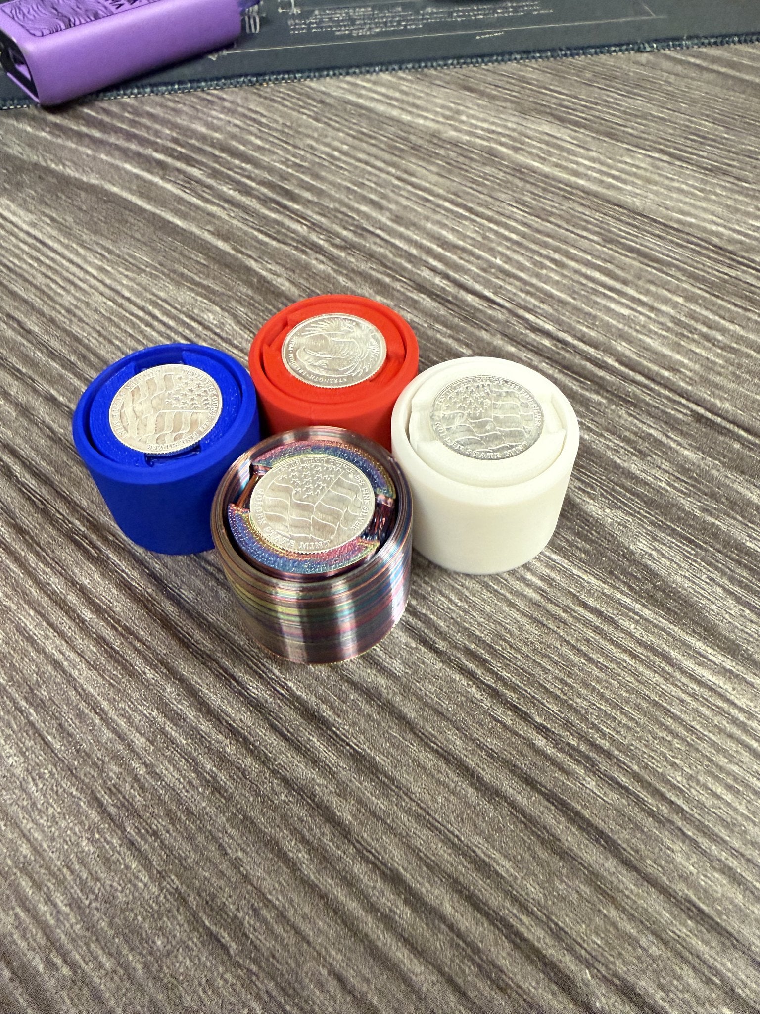 Group of Silver Coin Fidget Clickers in several PLA colors with silver rounds visible