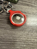 Apple AirTag seated in the back of the Coin AirTag Hiding Keychain — the bundle ships with both, ready to go